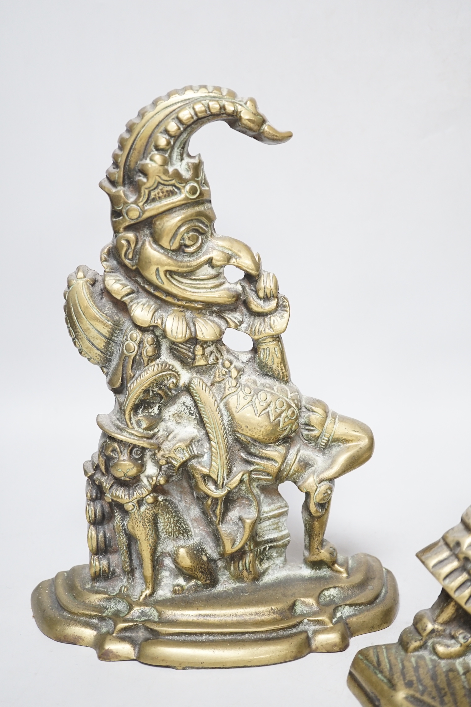 A pair of cast brass Punch and Judy door-stops, the largest 28cm high